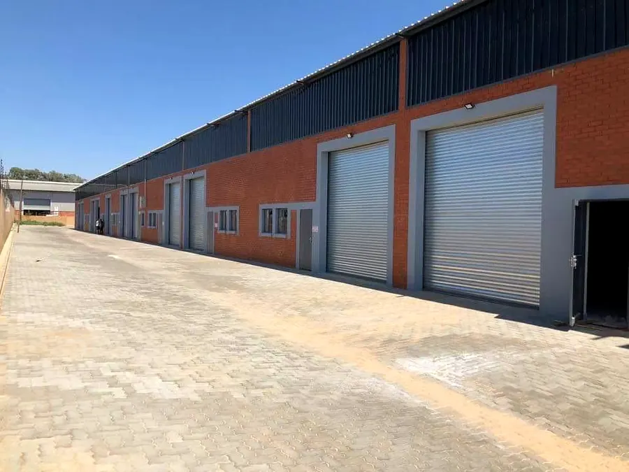 Face-brick industrial units with galvanised roller shutter doors