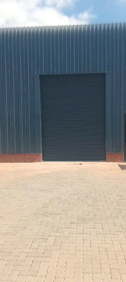 Charcoal roller shutter door on a steel-clad warehouse