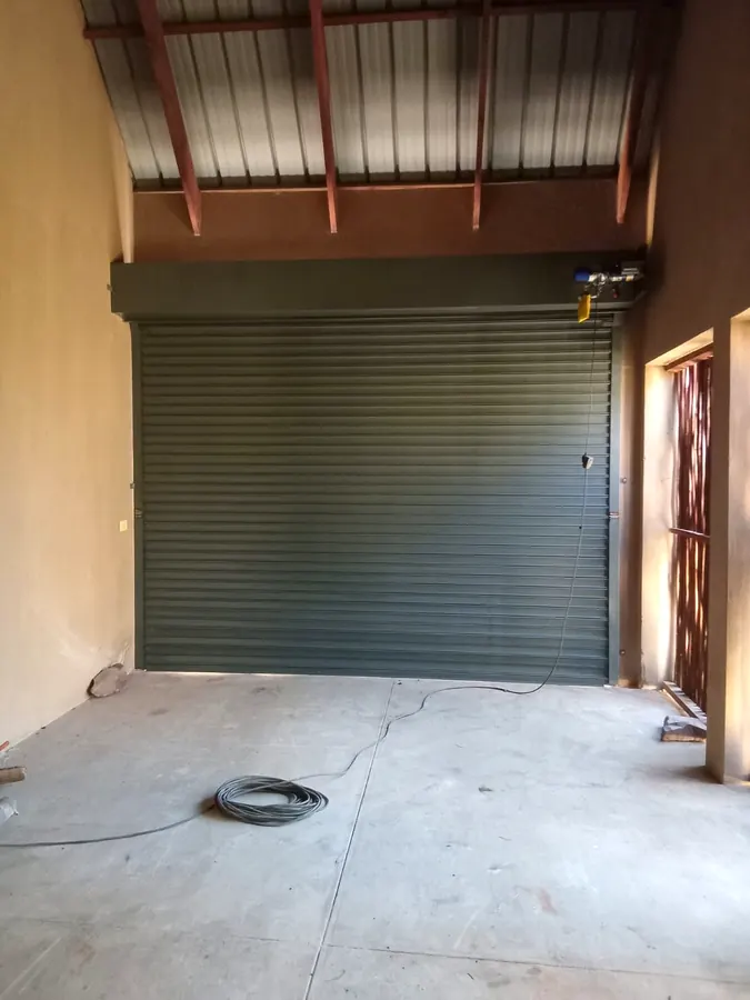 Charcoal roller shutter door fitted inside a workshop