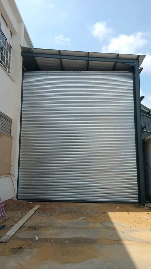 Galvanised roller shutter door installed on a new building extension