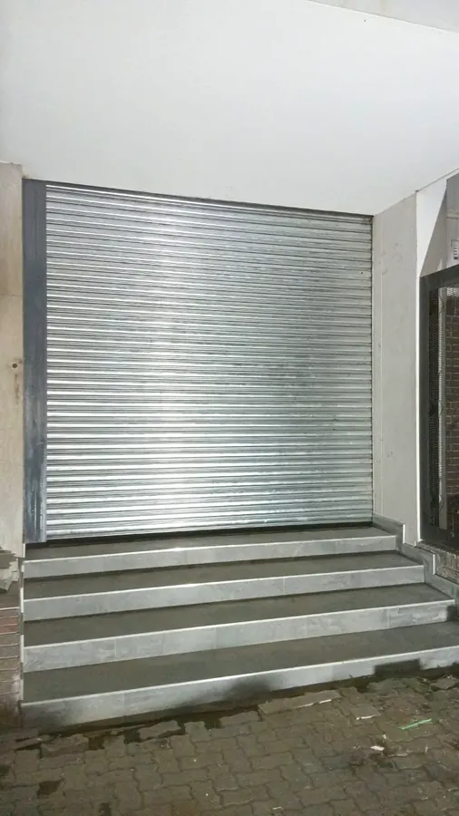 Galvanised roller shutter door above a stepped loading entrance