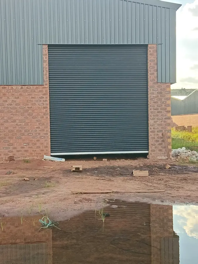 Industrial roller shutter door on a brick and steel warehouse