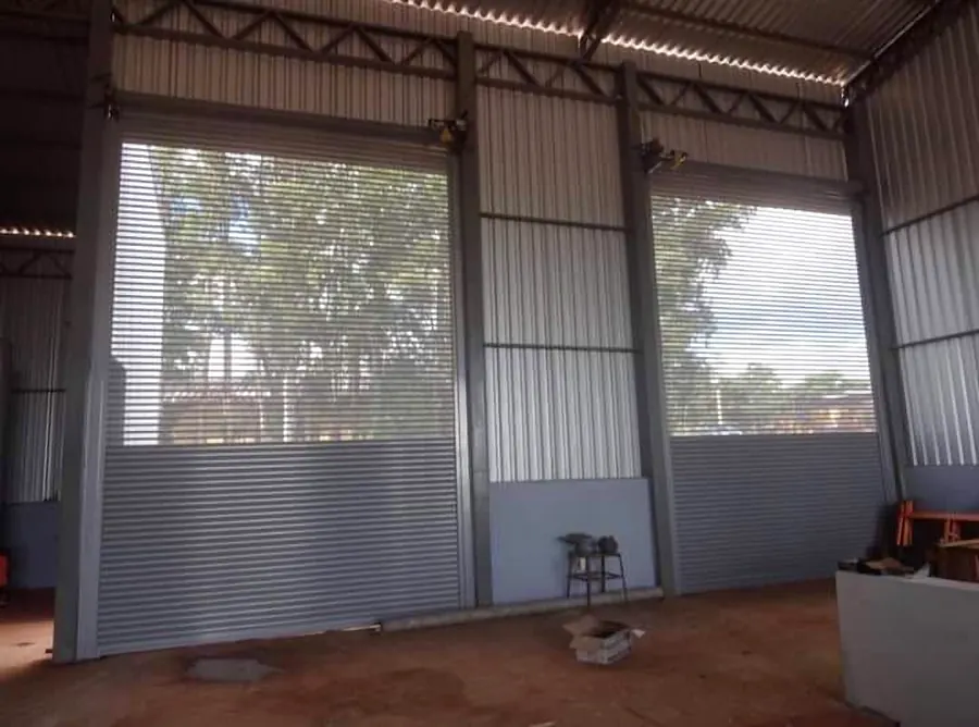 Large galvanised roller shutters in a steel shed