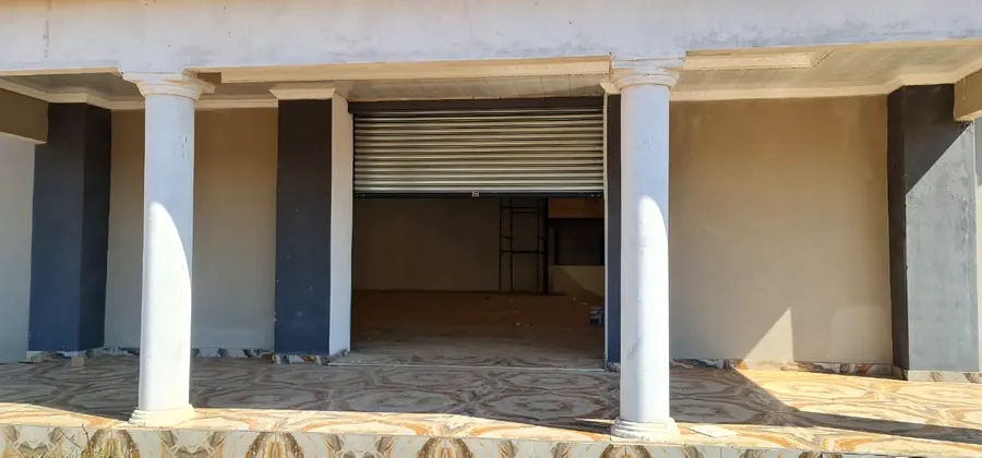 Retail unit with roller shutter rolled open