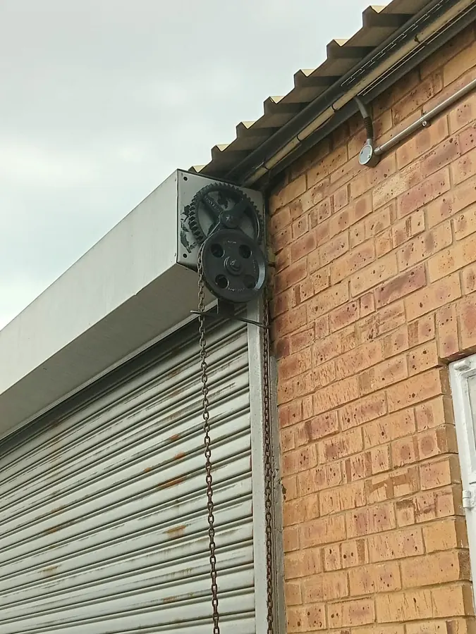 Roller shutter drive unit mounted on a brick building
