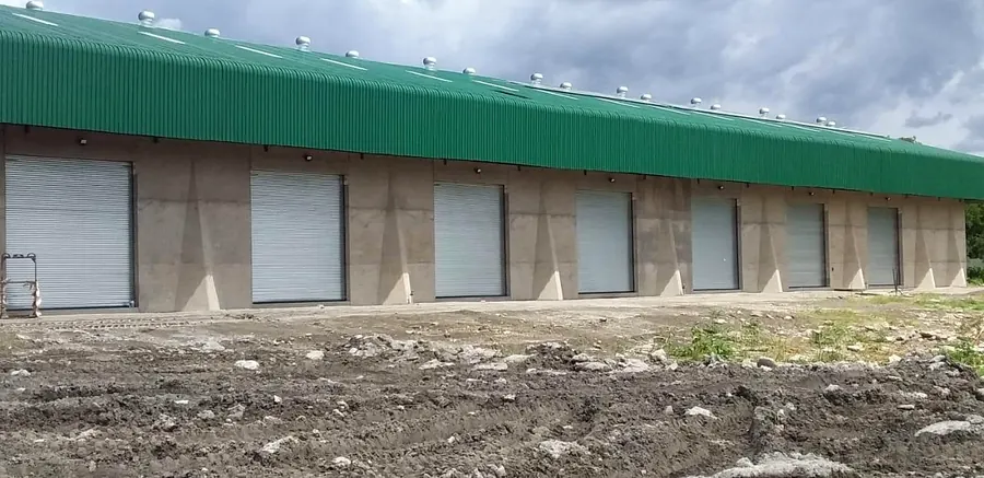 Row of galvanised roller shutters on an industrial building