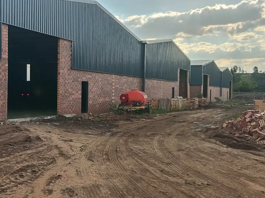 Brick warehouse units with roller shutter doors during construction